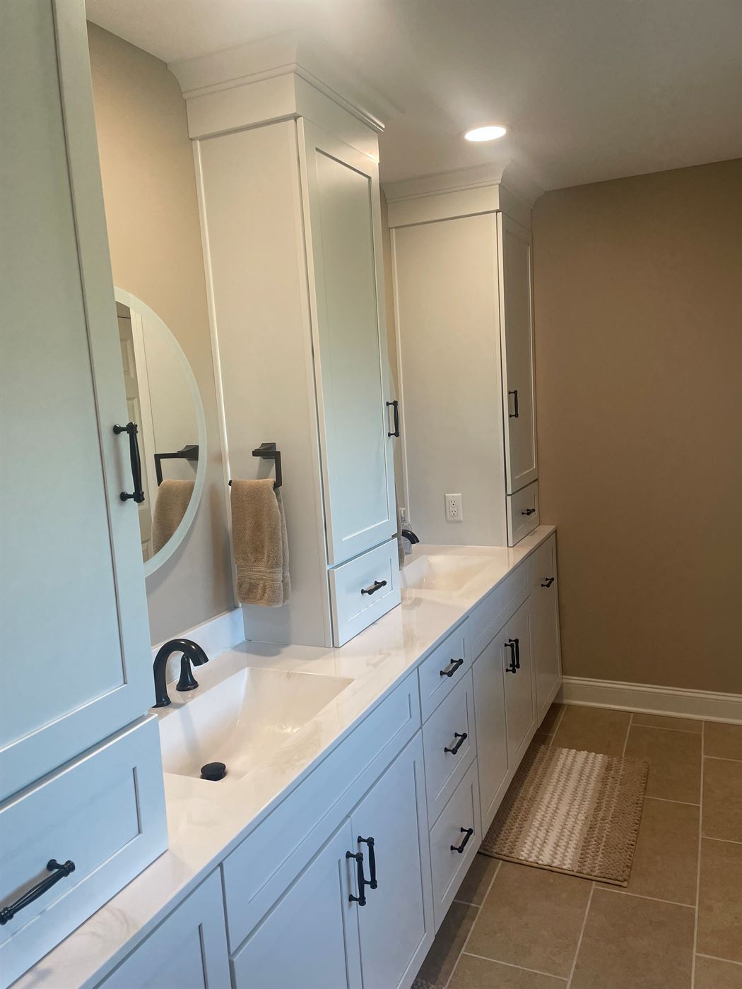 Long double vanity with tower cabinets by Stellar Construction