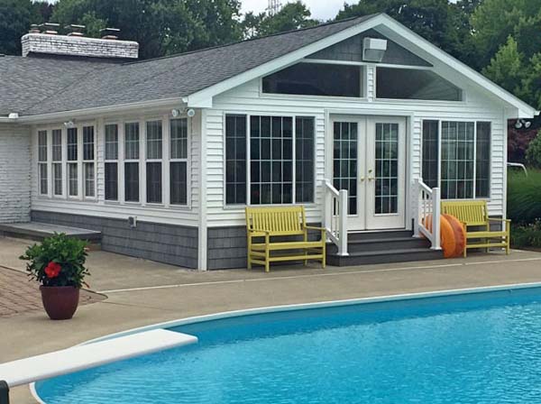 Four-season room addition beside a pool by Stellar Construction